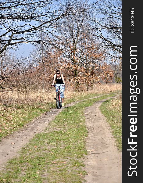 Girl riding a bike in beautiful spring scenery. Girl riding a bike in beautiful spring scenery