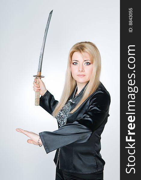 Portrait of woman with sword, studio shot