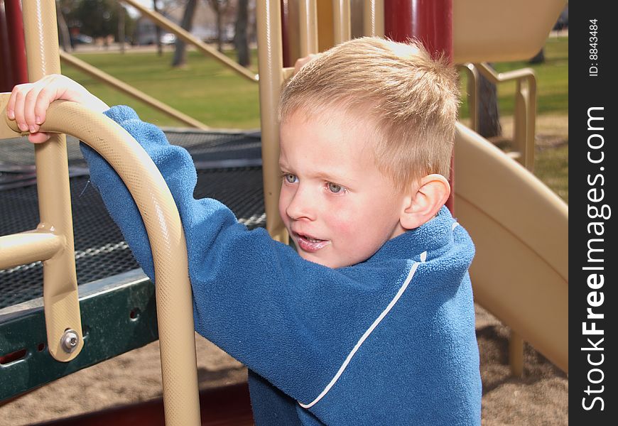A color image of a young boy playing at the park. A color image of a young boy playing at the park.