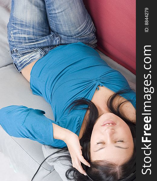Young woman relaxing on red couch