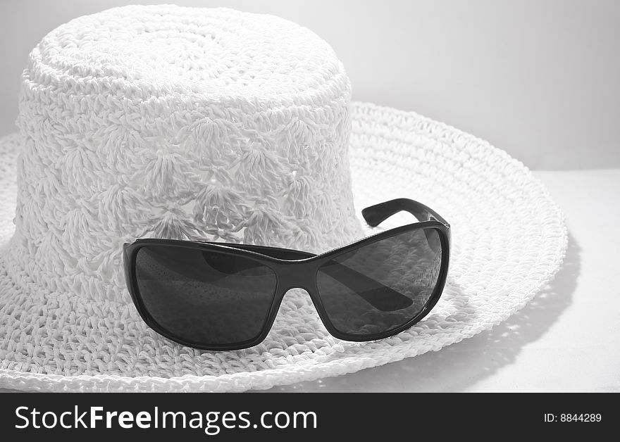 Hat with sunglasses, black and white photo. Hat with sunglasses, black and white photo
