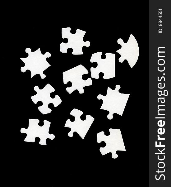 White jigsaw pieces on black background. White jigsaw pieces on black background.