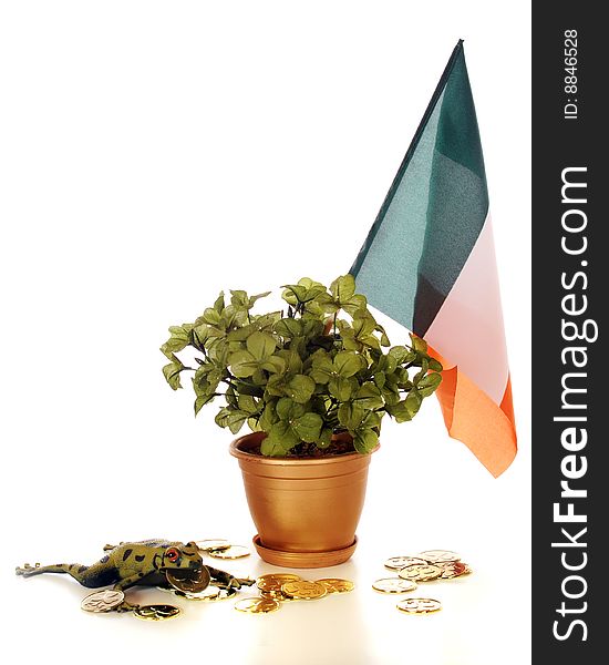 A frog carrying a gold coin by a gold clover-filled pot with an Irish flag. A frog carrying a gold coin by a gold clover-filled pot with an Irish flag.