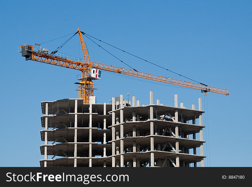 The elevating crane on clear blue sky background