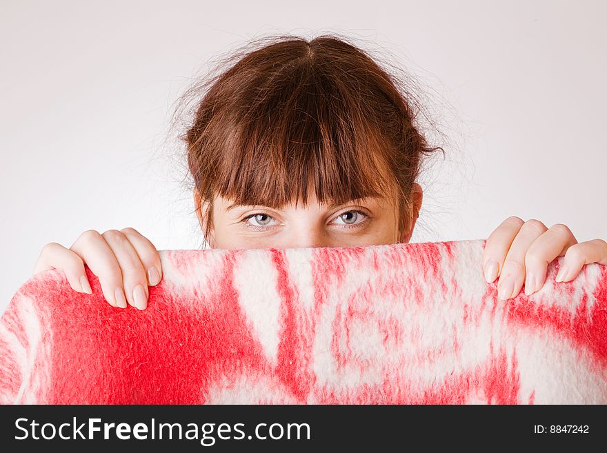 Young girl face hiding behind red towel. Young girl face hiding behind red towel