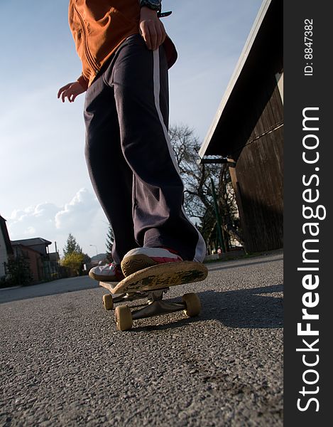A young teen skateboarding and having fun in a suburban setting. A young teen skateboarding and having fun in a suburban setting.