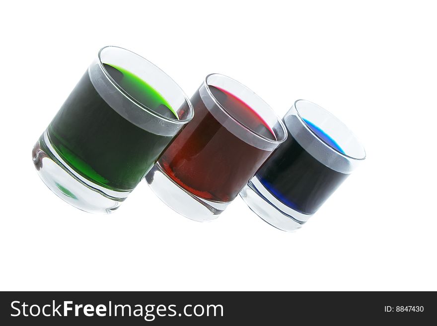 Three glasses with coloured cocktails isolated over white background. Three glasses with coloured cocktails isolated over white background