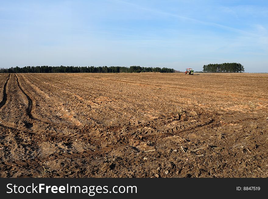 Tractor ploughing field in spring. Tractor ploughing field in spring