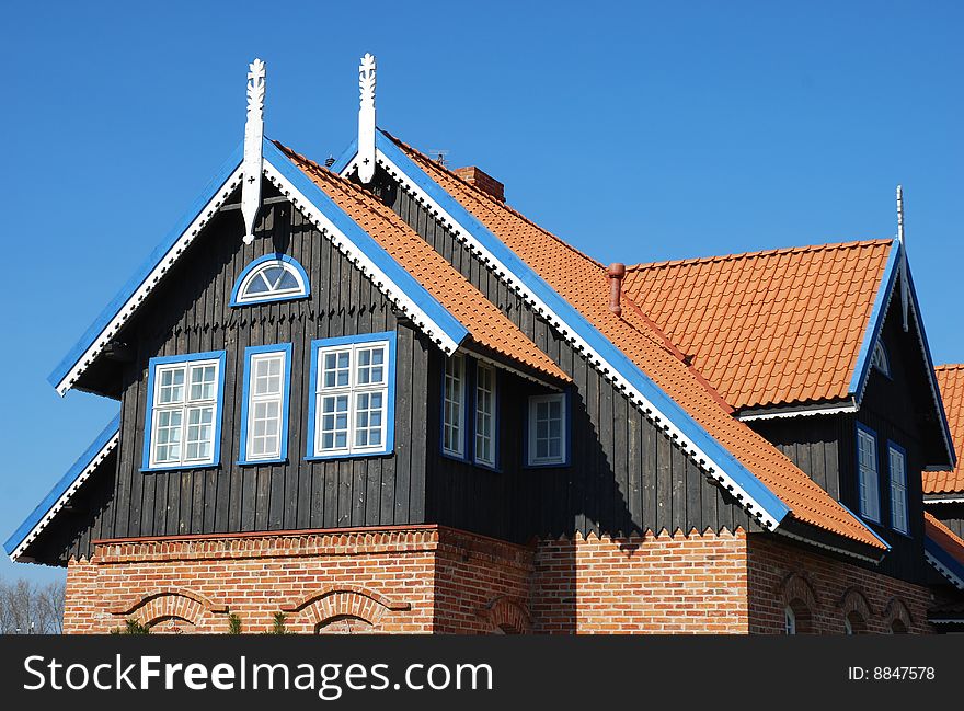 Fragment of a colorful country house with white wooden decorations in Lithuania,Europe. Fragment of a colorful country house with white wooden decorations in Lithuania,Europe