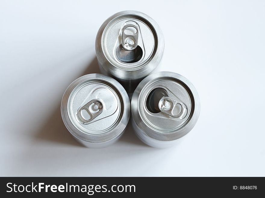 Two opened and one closed beer tins standing on white background. Two opened and one closed beer tins standing on white background