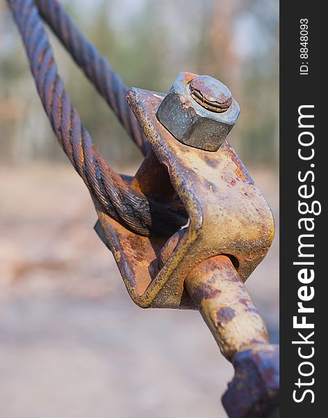 Close-up of rusting Eyelet Bolt with crimped stranded steel cable. Close-up of rusting Eyelet Bolt with crimped stranded steel cable.