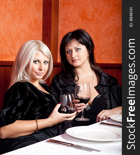 Two Female Friends Sitting At A Table