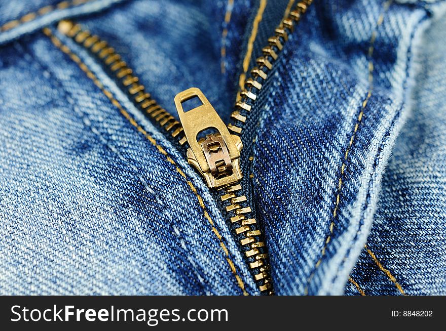 Horizontal closeup of the zipper of a stylish blue jeans. Horizontal closeup of the zipper of a stylish blue jeans