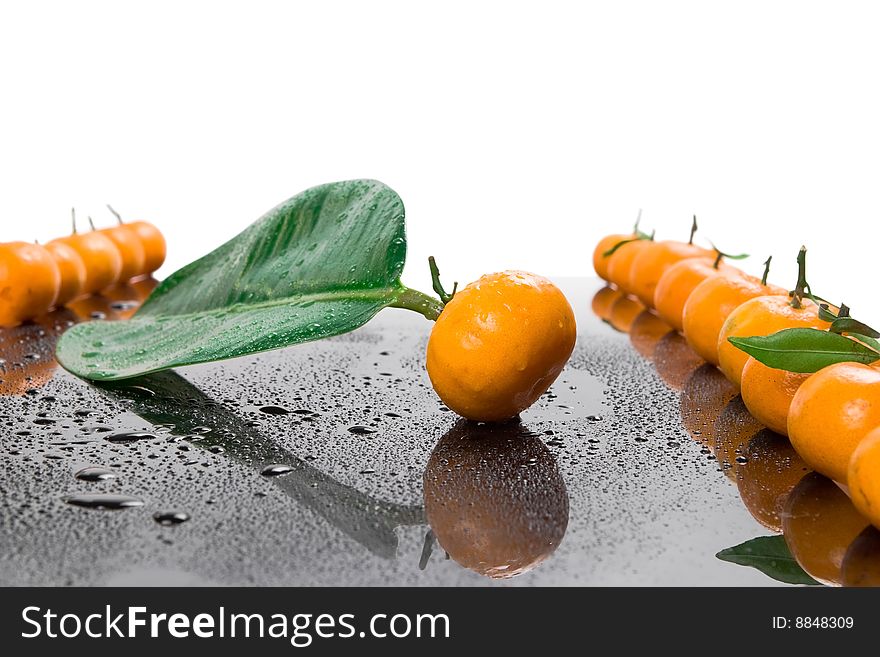 Tangerines lie in a row on the black