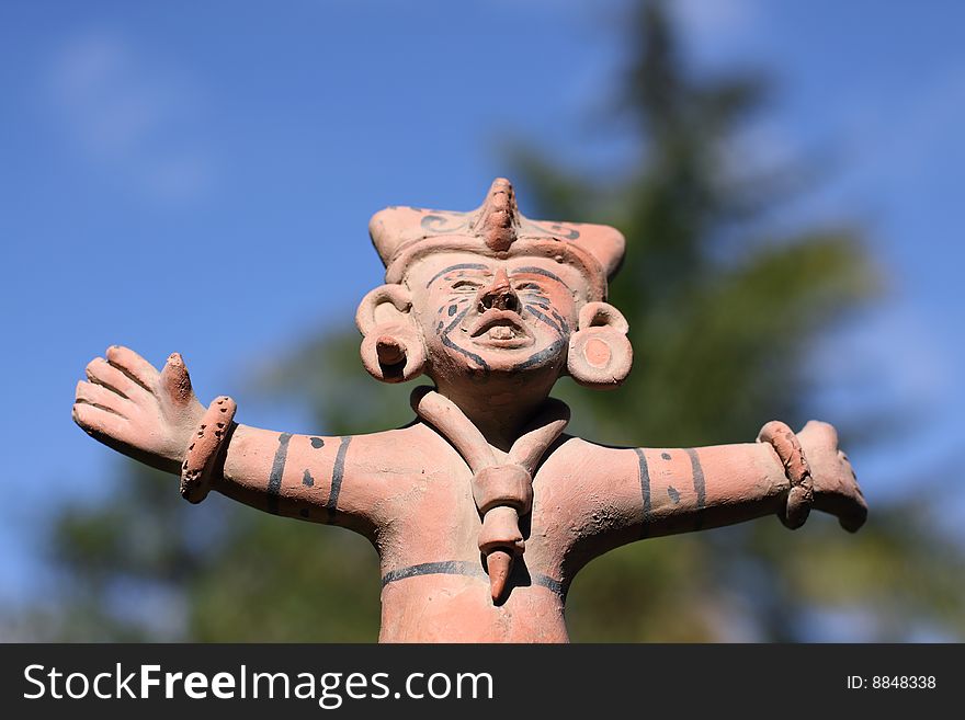 A clay, carved south American statue.