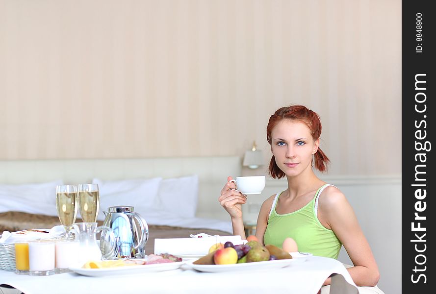 Cute young woman having breakfast