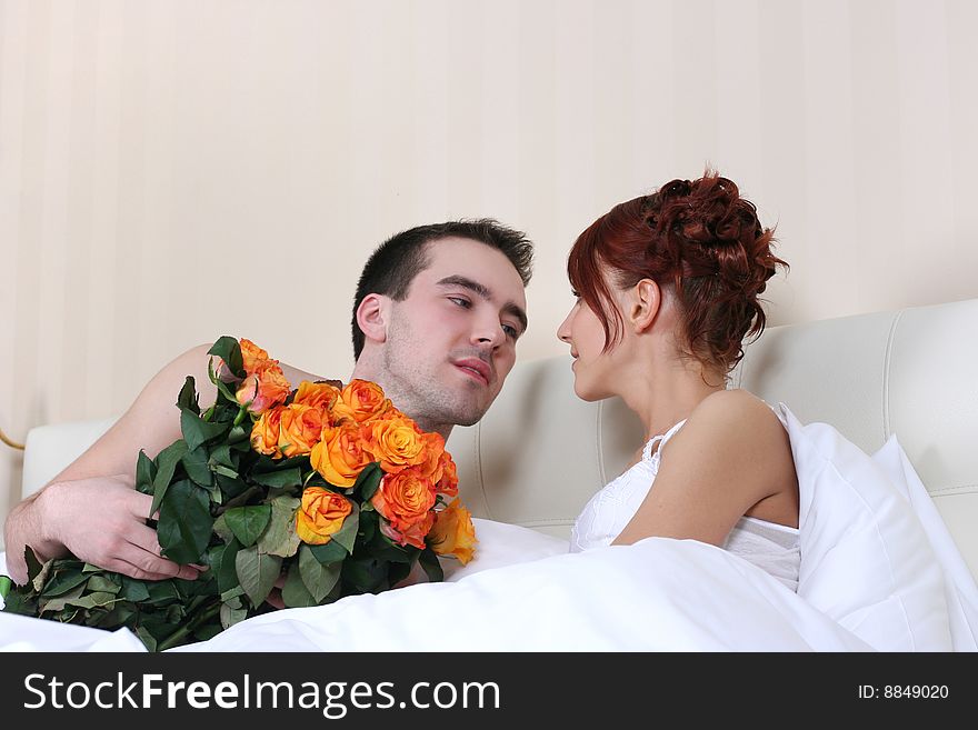 Young loving couple in relaxing bed