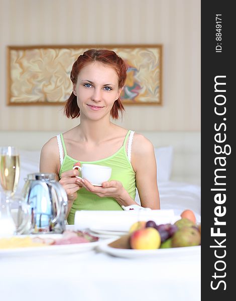 Cute young woman having breakfast