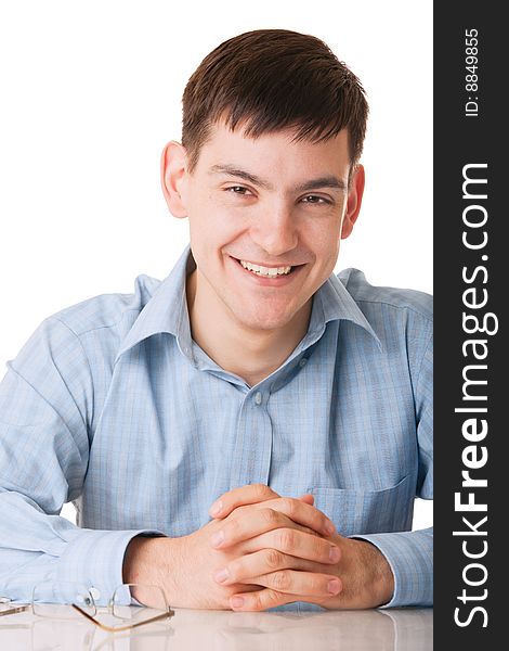 Young smiling man in blue shirt on white background