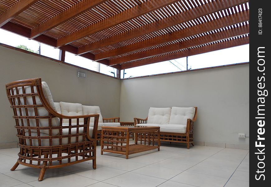 A patio with rattan furniture and cover. A patio with rattan furniture and cover.