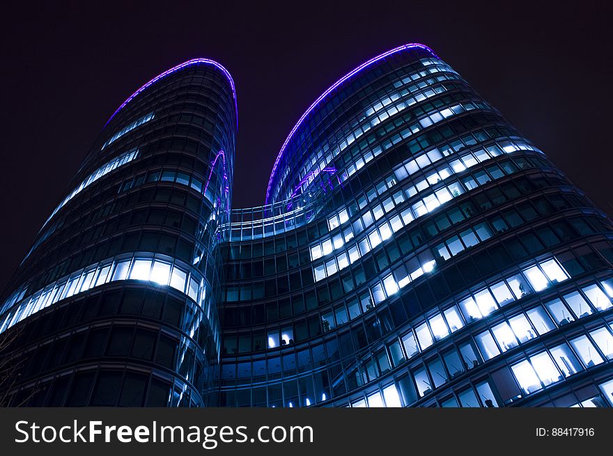 A modern skyscraper with purple lights on the roof. A modern skyscraper with purple lights on the roof.