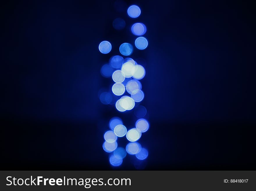 Abstract black background with blue bokeh lights shining. Abstract black background with blue bokeh lights shining.