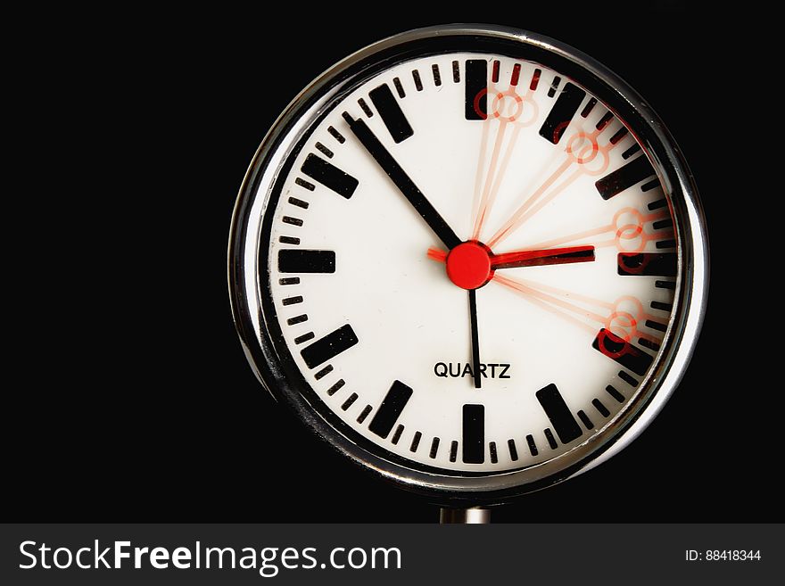 Circular clock with motion blur time effect for seconds, black background.