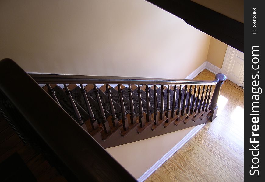 A staircase with railing in a house. A staircase with railing in a house.