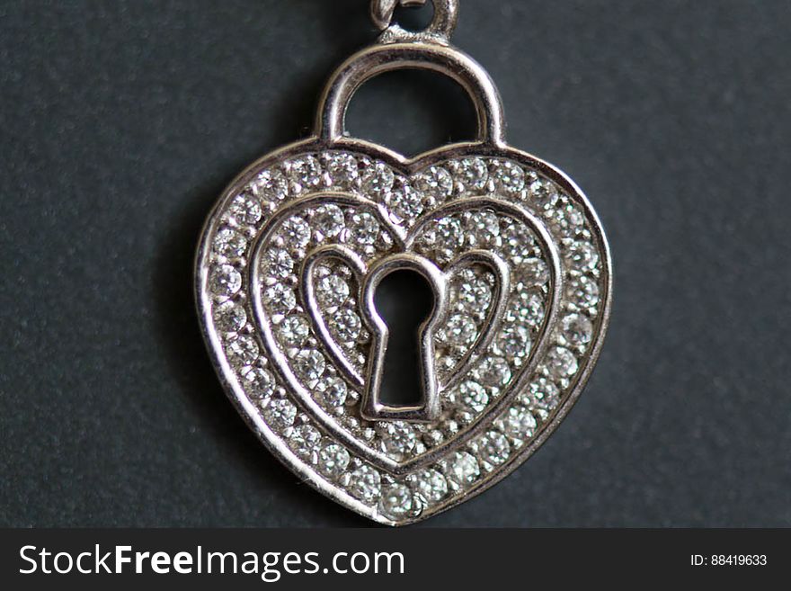 A heart shaped necklace with a keyhole. A heart shaped necklace with a keyhole.
