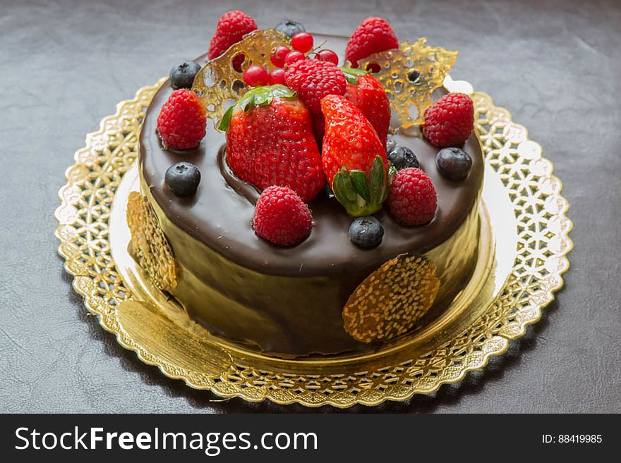A chocolate cake with blueberries, strawberries and raspberries and spun sugar. A chocolate cake with blueberries, strawberries and raspberries and spun sugar.
