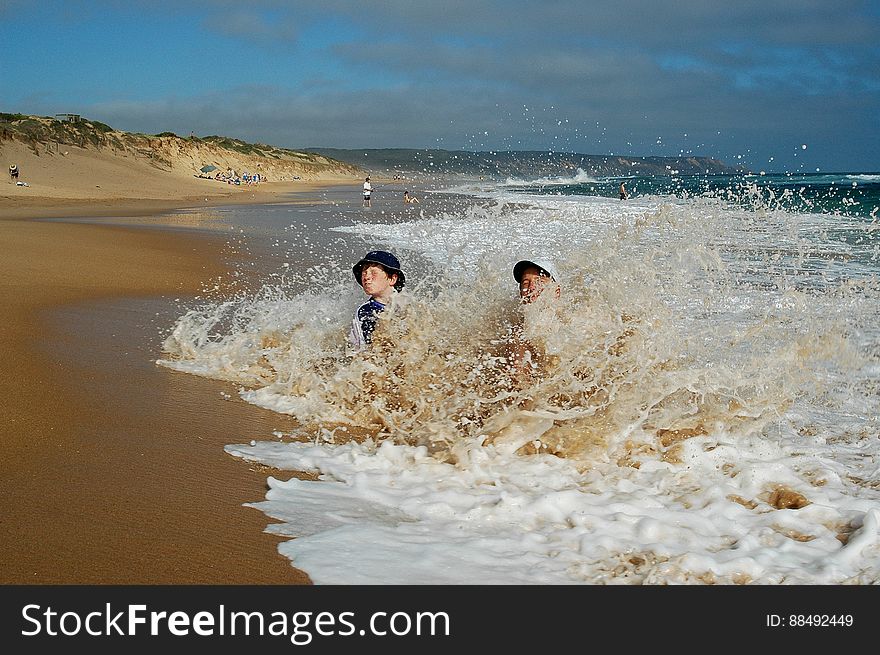 Boys Splashing In Waves