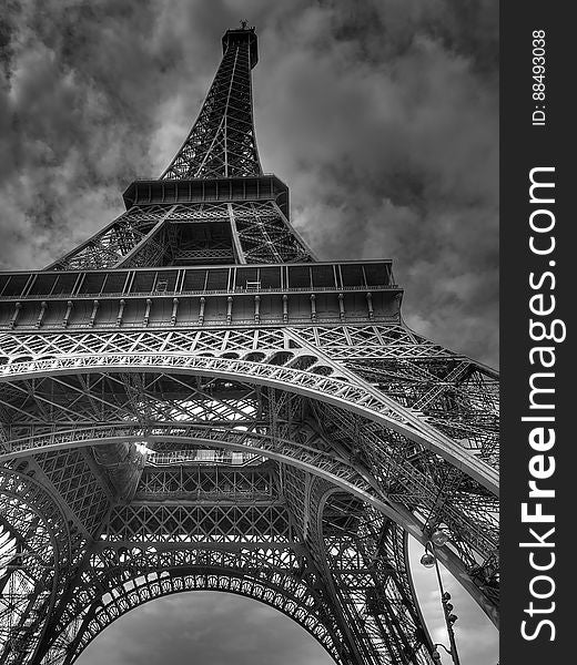 A black and white low angle perspective of the Eiffel Tower, Paris, France.