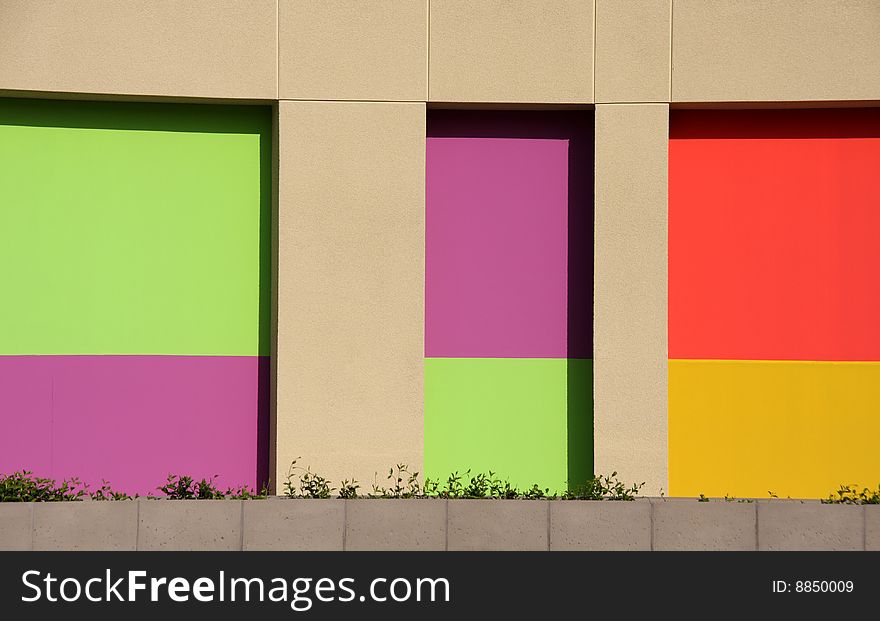Brightly colored wall with tan green purple red and gold