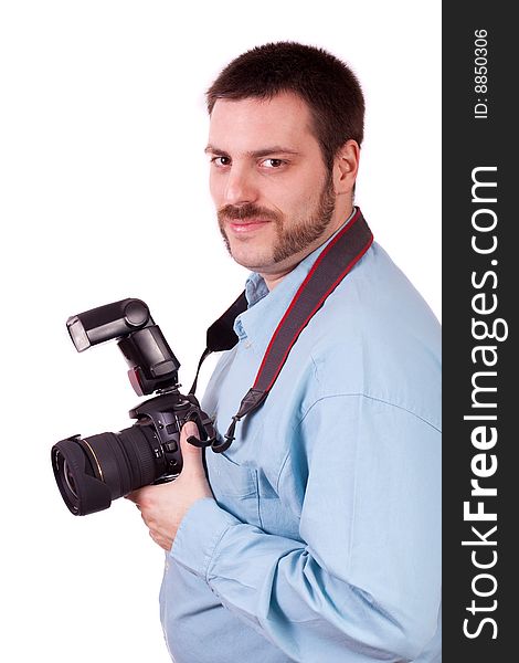 Young man holding SLR camera in his hand and smiling. Young man holding SLR camera in his hand and smiling