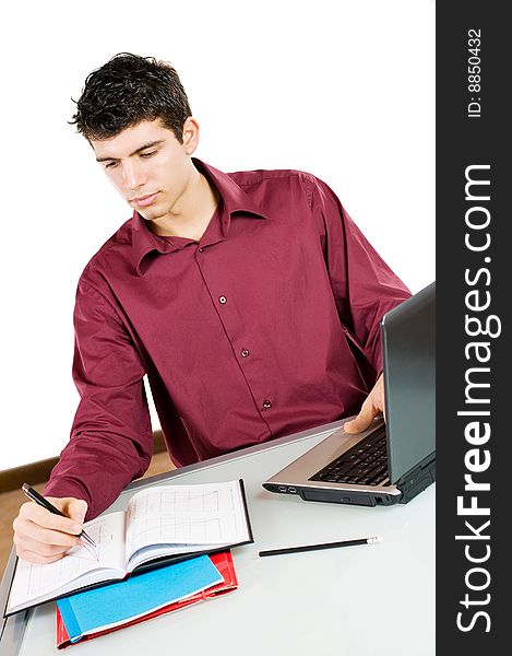 Young busy man studying and working on his laptop with note pad isolated on white background