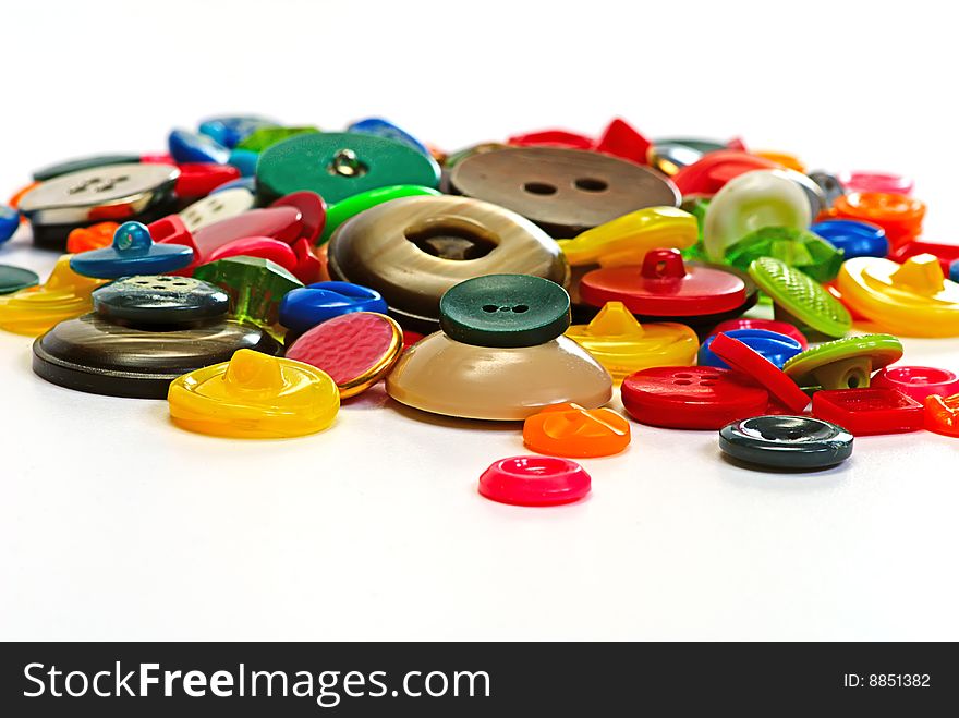 Colorful plastic buttons on white