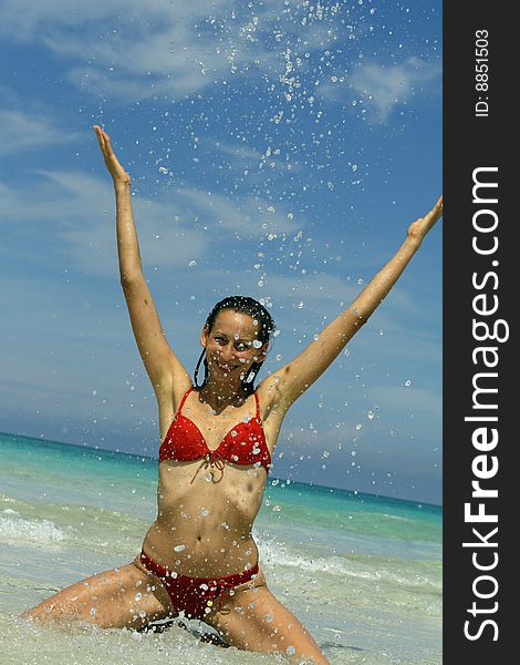 Woman splashing on the beach