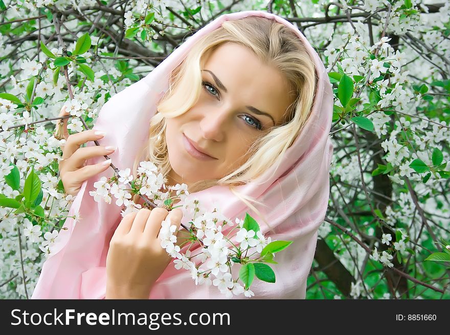 Girl in the cherry garden in spring. Girl in the cherry garden in spring