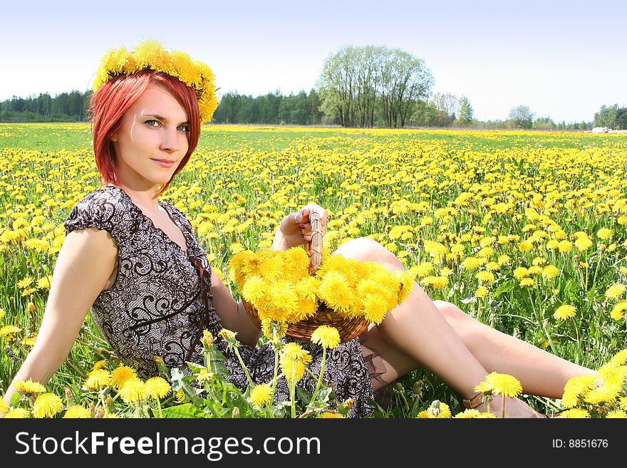 Beautiful redhead girl with basket of dandelions. Beautiful redhead girl with basket of dandelions