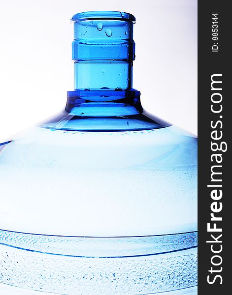 A large bottle of pure water on a white background detail. Studio work. A large bottle of pure water on a white background detail. Studio work.