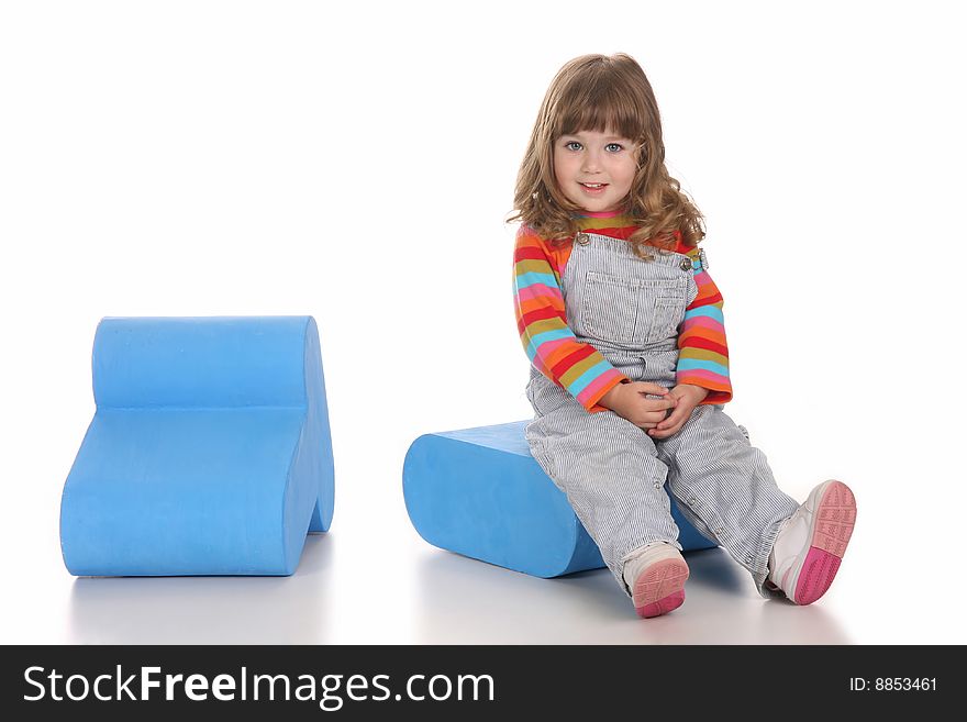 Beauty a little girl sitting on blue toy box