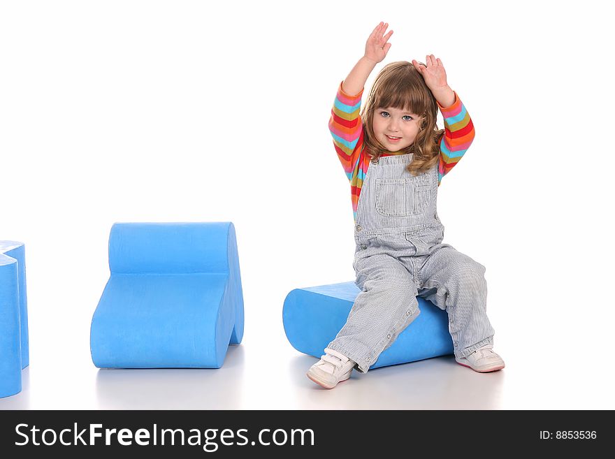 Beauty a little girl sitting on blue toy box