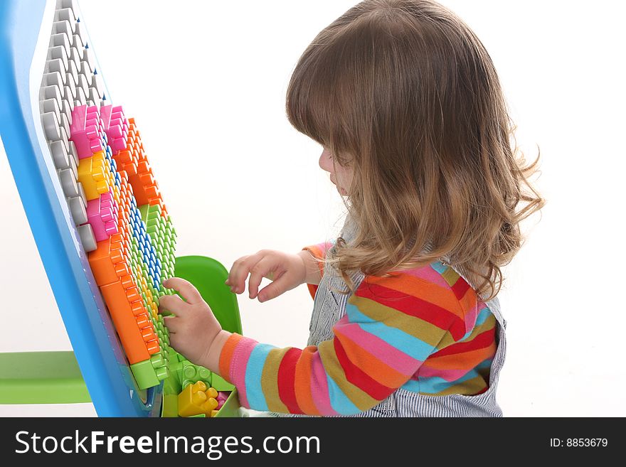 Beauty a little girl playing colorful building toy blocks
