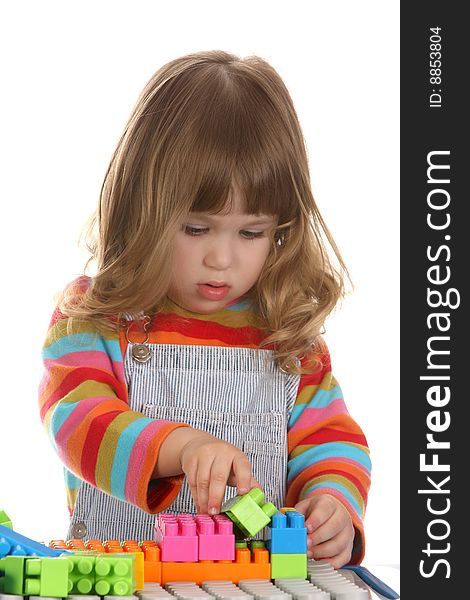 Beauty a little girl playing colorful building toy blocks