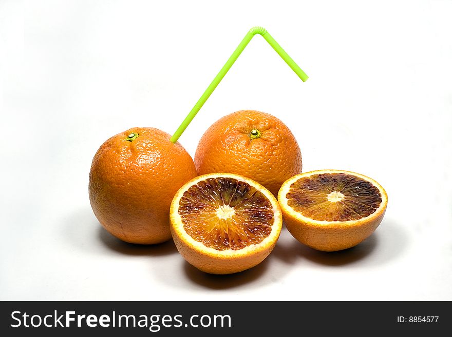 orange with straw on a white background. orange with straw on a white background