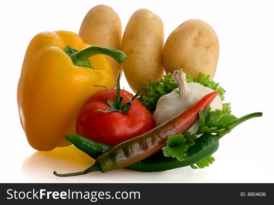 Tomato, garlic, pepper,  potatoes on a white background. Tomato, garlic, pepper,  potatoes on a white background