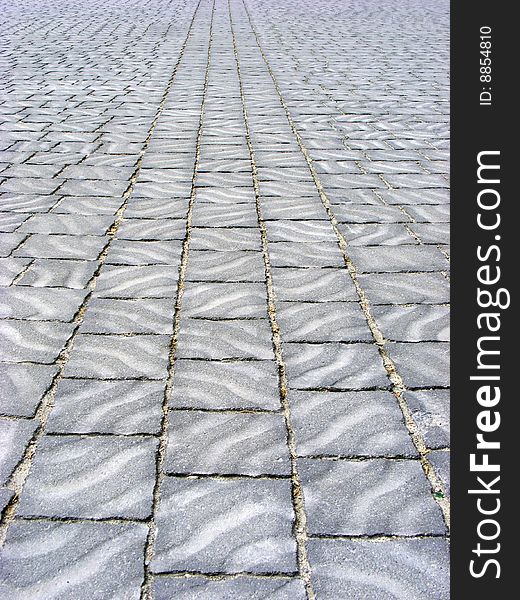 Area is covered with paving tiles with patterns