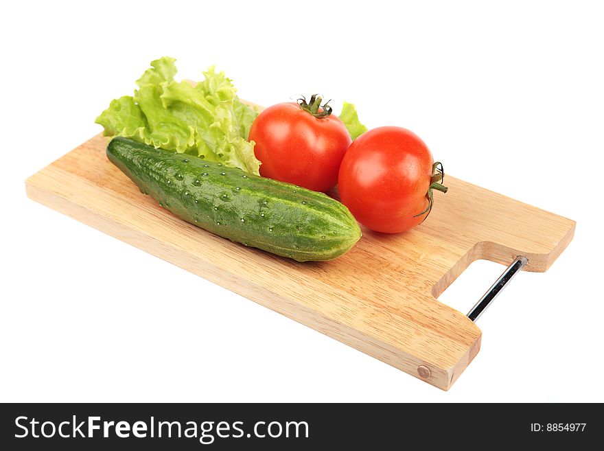 Vegetables on a wooden board on a white background