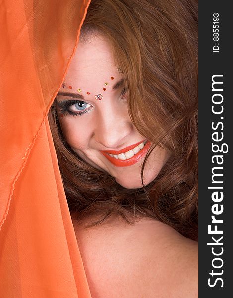 Belly Dancer wearing an orange costume with jewelery. Belly Dancer wearing an orange costume with jewelery