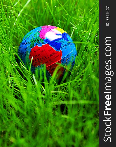 Earth globe in green grass, close up. Earth globe in green grass, close up